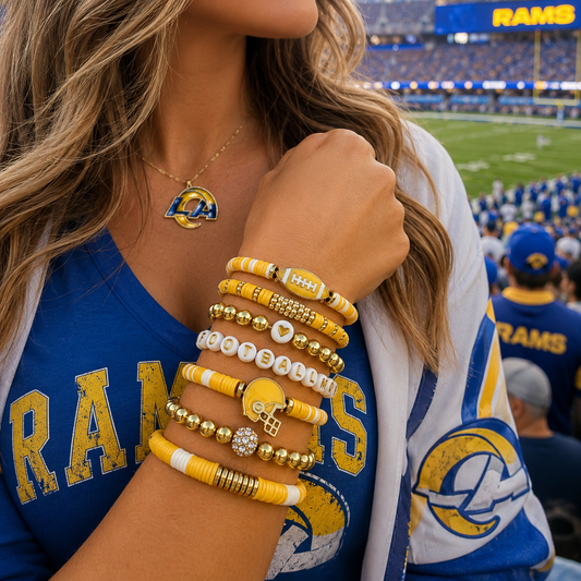 Person wearing Rams-themed jewelry and clothing at a sports event BRACELETS GOLDEN AND FOOTBALL MOM ON THE BEADS