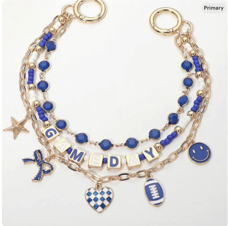 Multilayered bracelet with blue beads and various charms on a white background purse charm blue white and gold. Football Purse charm