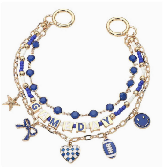 Multistrand bracelet with blue beads, gold accents, and various charms on a white background. Purse charm football. GameDay.  Blue and white and golf football purse charm
