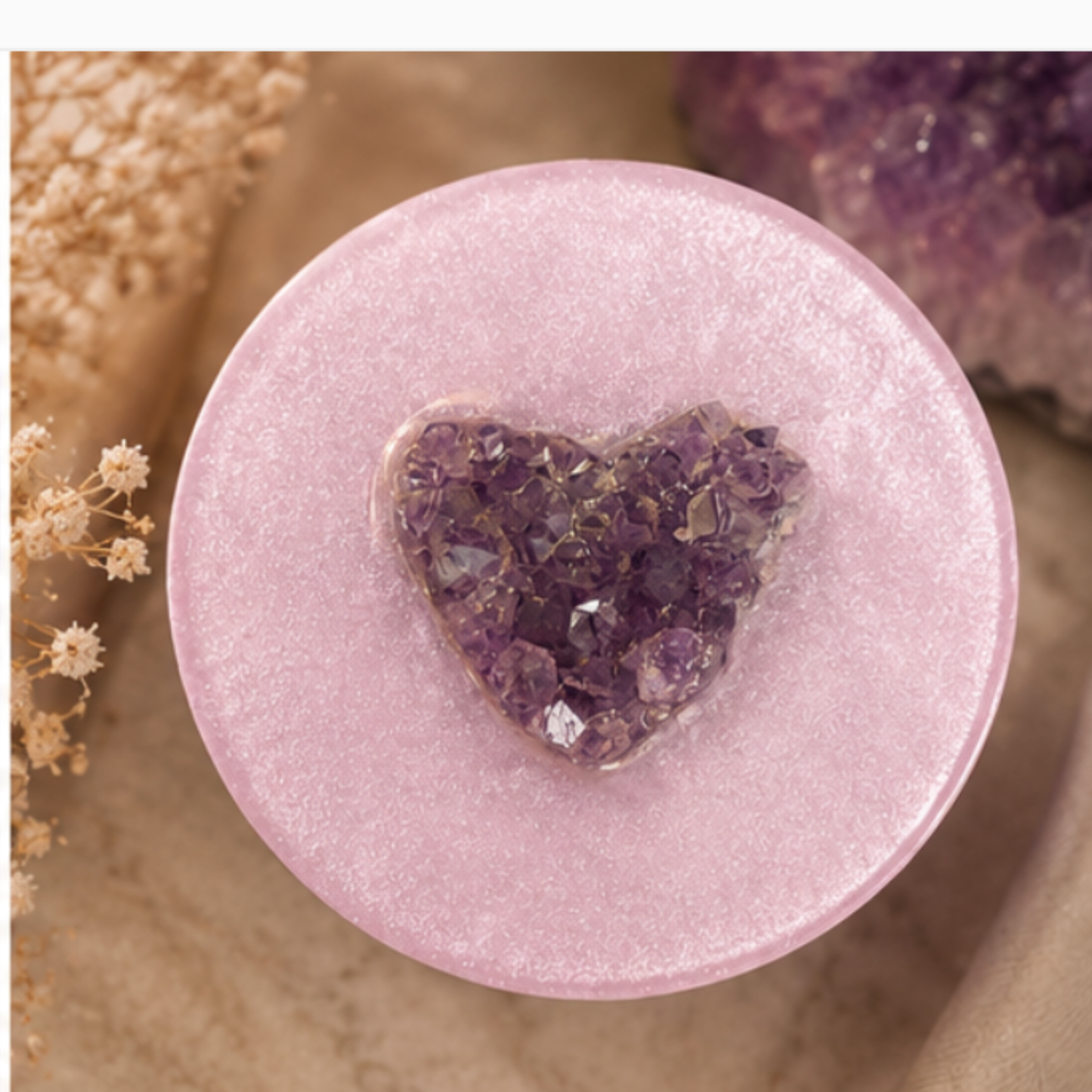 white pink lid with a heart-shaped amethyst crystal on a natural stone background