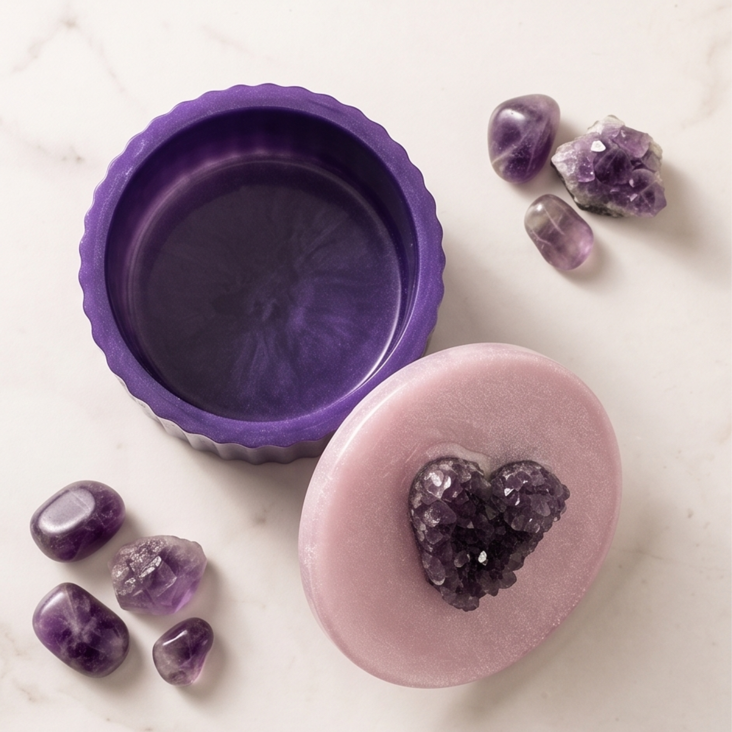 Purple silicone mold with a whitish lid featuring an amethyst crystal on a white marble surface.