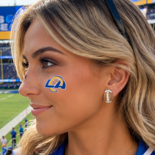 Woman with Rams face paint and earrings at a sports event wearing football rhinstone earrings
