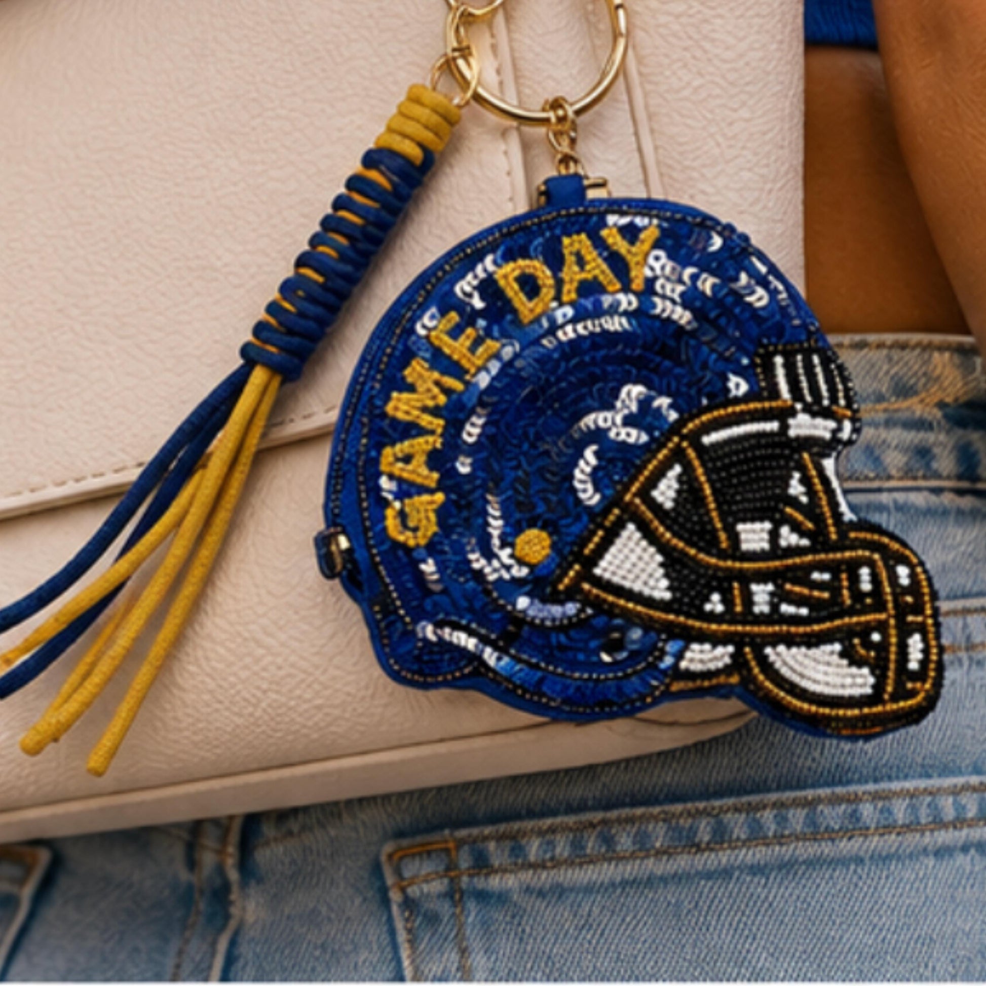 Keychain with 'Game Day' helmet design on a denim surface sequense