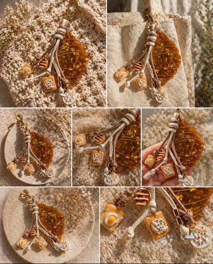 Collage of a croissant keychain and brunch charms egg on toast cinnamon buns cereal and pop tart 